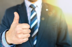 man in suit giving thumbs up