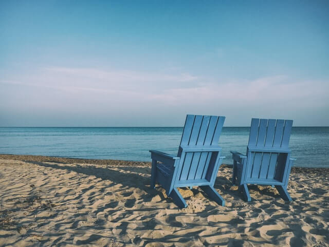two blue chairs beach happy retirement