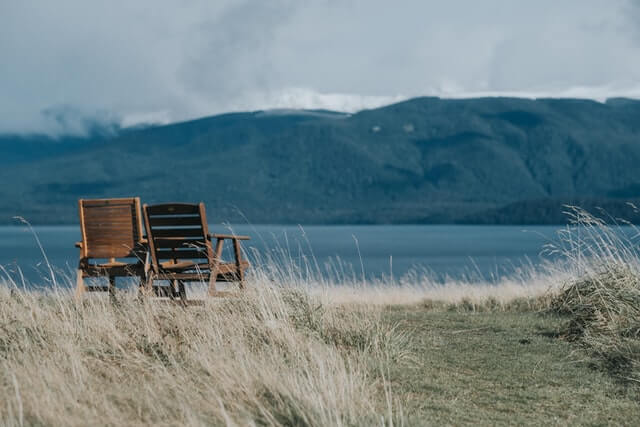 chairs overlooking lake mountain