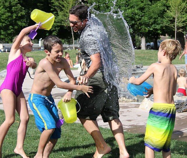 dad having water fight with kids